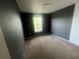 Neutral carpeted bedroom with a window that lets in natural light at 4650 Staghorn Dr # 500, Orlando, FL 32808