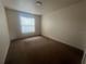 Neutral carpeted bedroom with a window that lets in natural light at 4650 Staghorn Dr # 500, Orlando, FL 32808