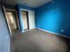 Bedroom featuring blue walls, neutral carpet, and a closet at 4650 Staghorn Dr # 500, Orlando, FL 32808