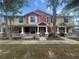 Charming townhouse featuring a cozy front porch with stone accents and a well-maintained lawn at 4650 Staghorn Dr # 500, Orlando, FL 32808