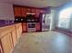 Spacious kitchen featuring stainless steel appliances, wood cabinets, and tile flooring at 4650 Staghorn Dr # 500, Orlando, FL 32808