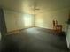 Bright living room with plush carpeting, ceiling fan, and natural light at 4650 Staghorn Dr # 500, Orlando, FL 32808