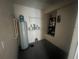 Utility room featuring a water heater, shelving, and the air conditioning unit at 4650 Staghorn Dr # 500, Orlando, FL 32808