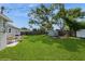 Expansive backyard with lush green grass, mature trees, and a shed for extra storage at 4816 Crow St, Orlando, FL 32819