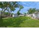 Expansive backyard features mature trees, a storage shed, and a swing set perfect for outdoor activities at 4816 Crow St, Orlando, FL 32819