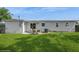 Well-maintained backyard featuring a patio set and lush green grass perfect for outdoor entertaining at 4816 Crow St, Orlando, FL 32819