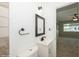 Close up of bathroom showcasing decorative mirror, single sink vanity, and toilet at 4816 Crow St, Orlando, FL 32819