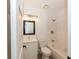 Bright bathroom with a modern vanity, decorative mirror, and a shower-tub combination at 4816 Crow St, Orlando, FL 32819
