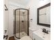 Updated bathroom showcasing a stand up shower with elegant tile, modern vanity, and decorative mirror at 4816 Crow St, Orlando, FL 32819