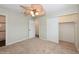 Bedroom featuring a ceiling fan, neutral walls, plush carpet, and a closet for storage at 4816 Crow St, Orlando, FL 32819