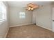This bedroom features neutral walls, plush carpet, and one window that allows ample natural light at 4816 Crow St, Orlando, FL 32819
