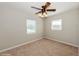 This bedroom features neutral walls, carpeted floors, a ceiling fan, and natural light at 4816 Crow St, Orlando, FL 32819