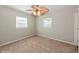 This bedroom features neutral walls, plush carpet, and two windows that allow ample natural light at 4816 Crow St, Orlando, FL 32819