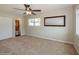 Bright bedroom with carpeted floor, ceiling fan, closet, large window, and ensuite bathroom access at 4816 Crow St, Orlando, FL 32819
