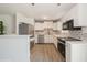 Modern kitchen featuring white cabinets, stainless steel appliances, and stylish backsplash at 4816 Crow St, Orlando, FL 32819