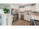 This updated kitchen is complete with stainless steel appliances, white cabinets, and modern backsplash at 4816 Crow St, Orlando, FL 32819