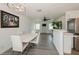 Spacious living room featuring modern chandelier, neutral walls, stylish furniture, and an abundance of natural light at 4816 Crow St, Orlando, FL 32819