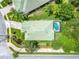 Aerial view of the property showcasing its green tile roof, pool, and landscaped yard at 487 Foxhill Dr, Debary, FL 32713