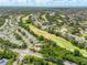 Stunning aerial view of a lush golf course community with well-maintained homes and beautiful landscaping at 487 Foxhill Dr, Debary, FL 32713