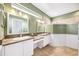 Bathroom with double sinks, tile floors, and walk-in shower at 487 Foxhill Dr, Debary, FL 32713