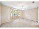 Empty bedroom with bay windows, carpet, and ceiling fan at 487 Foxhill Dr, Debary, FL 32713