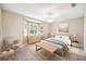 Bedroom featuring natural light, neutral color, with a ceiling fan, furniture, and artwork at 487 Foxhill Dr, Debary, FL 32713