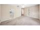 Bedroom with bathroom and kitchen views, neutral walls, ceiling fan, and door to patio at 487 Foxhill Dr, Debary, FL 32713