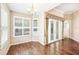 Dining area with plantation shutters, hardwood floors, French doors, and modern chandelier at 487 Foxhill Dr, Debary, FL 32713