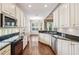 Kitchen with white cabinets, granite countertops, and stainless steel appliances at 487 Foxhill Dr, Debary, FL 32713