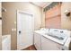 Cozy laundry room with washer, dryer, sink and storage space at 487 Foxhill Dr, Debary, FL 32713
