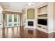 Living room features a fireplace, built-in shelves, and french doors leading to the pool at 487 Foxhill Dr, Debary, FL 32713