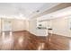 Open-concept living area connecting to the kitchen and entryway with hardwood floors at 487 Foxhill Dr, Debary, FL 32713