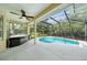 Relaxing screened-in pool area with a hot tub and green landscape view at 487 Foxhill Dr, Debary, FL 32713