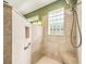 Shower with glass block window, tile surround, and built-in seat at 487 Foxhill Dr, Debary, FL 32713