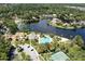 Aerial view of community pool, tennis court, parking and lake surrounded by lush greenery at 5154 Majestic Woods Pl, Sanford, FL 32771