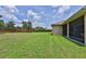Expansive backyard with lush green grass, privacy fence, and mature trees at 5154 Majestic Woods Pl, Sanford, FL 32771