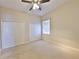 Carpeted bedroom with ceiling fan, a window with blinds, and double closets at 5154 Majestic Woods Pl, Sanford, FL 32771