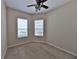 A carpeted bedroom featuring two windows with blinds and a ceiling fan at 5154 Majestic Woods Pl, Sanford, FL 32771