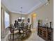 Dining room with tray ceiling, elegant chandelier, and decorative accents at 5154 Majestic Woods Pl, Sanford, FL 32771