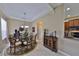 Dining room with tray ceiling, elegant chandelier, and direct access to the kitchen at 5154 Majestic Woods Pl, Sanford, FL 32771
