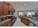 Kitchen with stainless steel appliances and dark wood cabinets overlooks the dining area at 5154 Majestic Woods Pl, Sanford, FL 32771