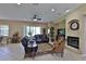 Spacious living room features comfortable seating, a cozy fireplace, and a ceiling fan at 5154 Majestic Woods Pl, Sanford, FL 32771