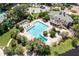 Aerial view of an oversized pool with lap lanes and various lounge areas, surrounded by lush landscaping at 5154 Majestic Woods Pl, Sanford, FL 32771