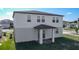 Charming backyard features a covered patio, offering a cozy outdoor space for relaxation and entertainment at 596 Sun Warbler Way, St Cloud, FL 34771