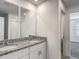 Bathroom features double sink vanity, granite countertop, and tiled shower, providing modern convenience at 596 Sun Warbler Way, St Cloud, FL 34771