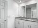 Bathroom features double sink vanity, granite countertop, and tiled shower, providing modern convenience at 596 Sun Warbler Way, St Cloud, FL 34771