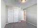 Cozy bedroom with closet and neutral walls with plush carpeting, perfect for relaxation and comfort at 596 Sun Warbler Way, St Cloud, FL 34771
