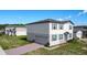 Beautiful two-story home with a side-entry garage and brick paver driveway, showcasing modern design and well-kept landscaping at 596 Sun Warbler Way, St Cloud, FL 34771