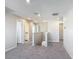 Bright hallway featuring neutral walls and plush gray carpeting leading to bedrooms and bathrooms at 596 Sun Warbler Way, St Cloud, FL 34771
