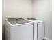 Modern laundry room featuring a front-load washing machine and dryer for efficient laundry care at 596 Sun Warbler Way, St Cloud, FL 34771
